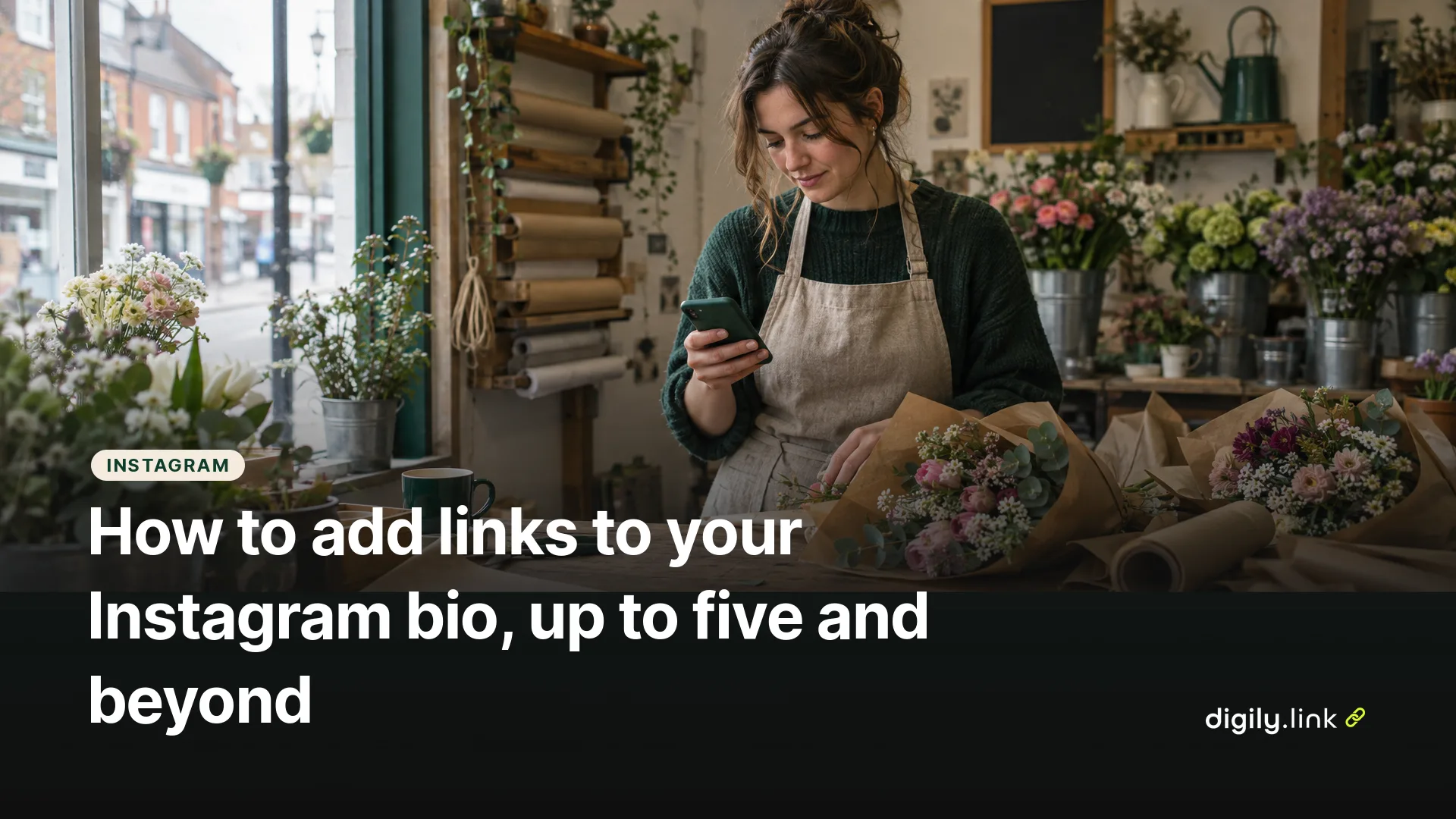 A florist holding a phone over a workbench of wrapped bouquets